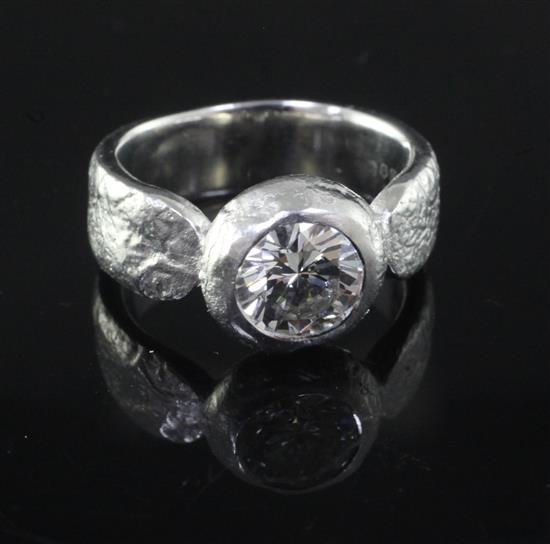 A Pruden and Smith modern heavy platinum and collet set solitaire diamond ring, size 0.